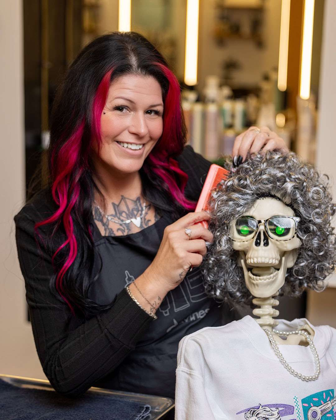 Casandra, hairstylist at Salon 730 in Fredericksburg VA brushing a skeleton's hair