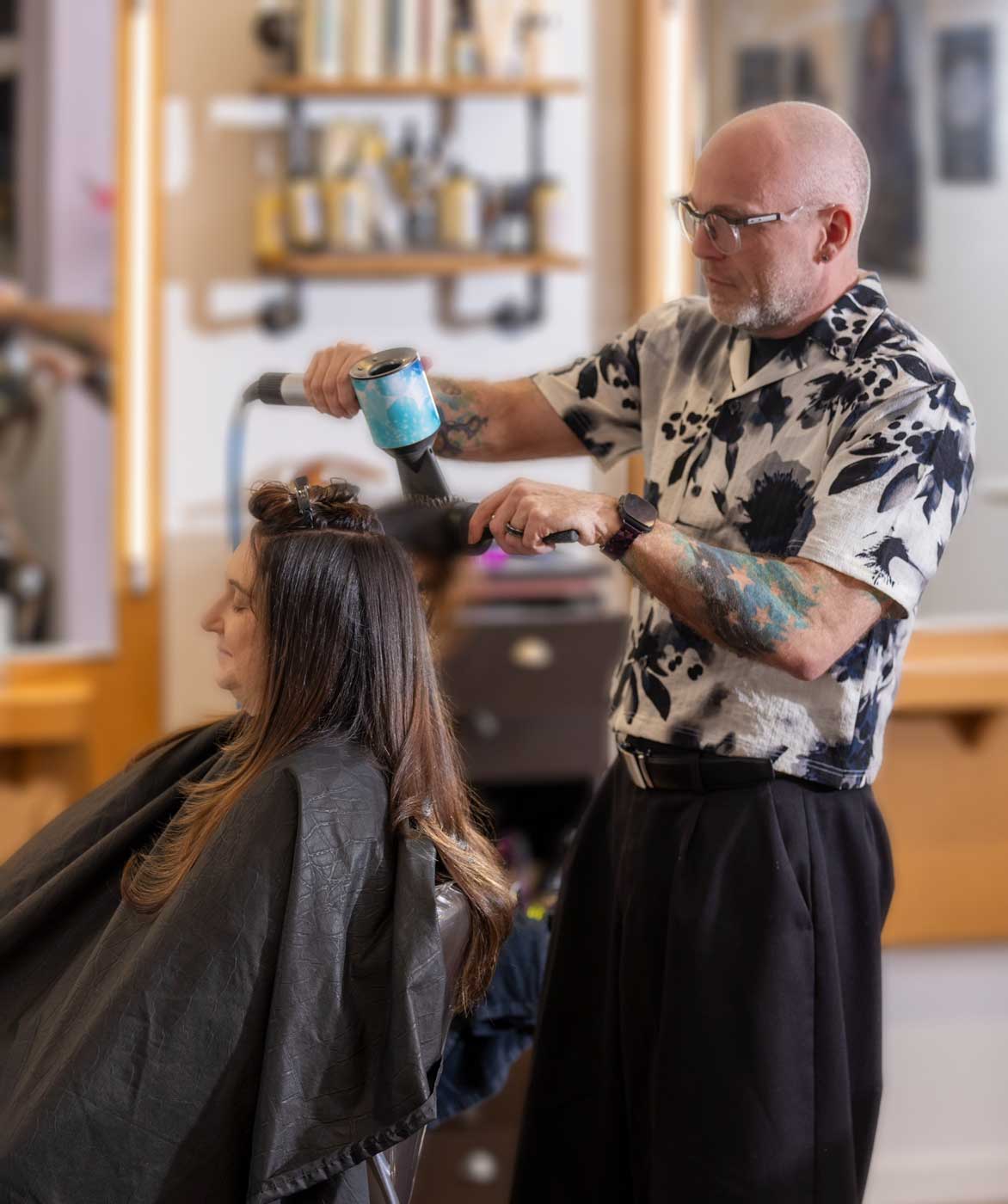 Salon stylist blow drying client's hair at Salon 730