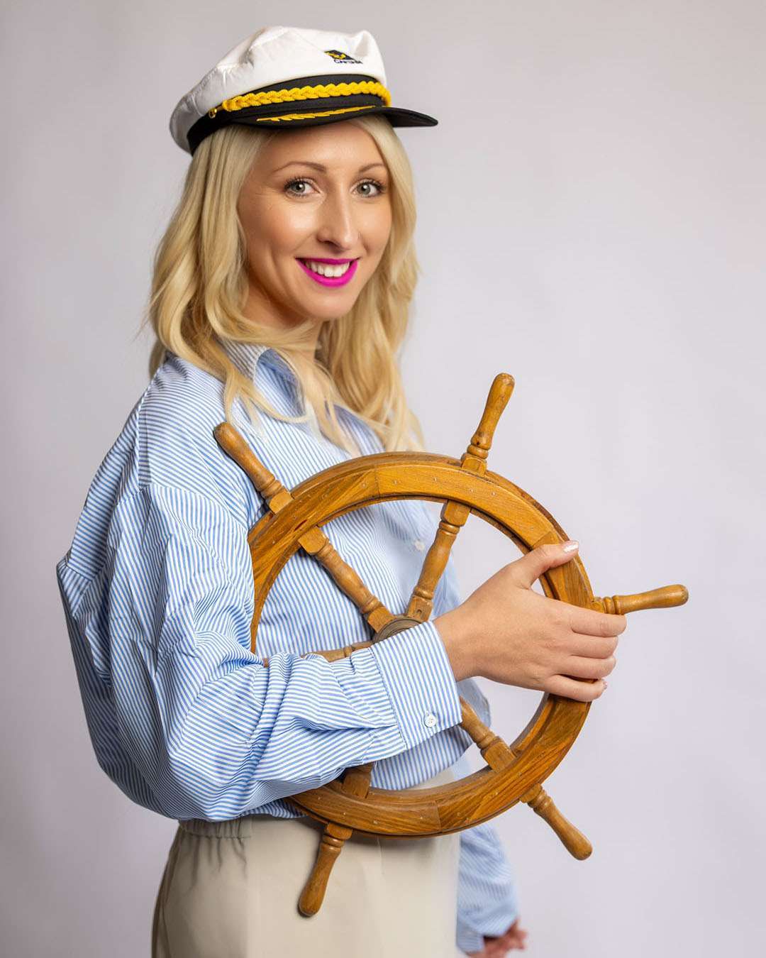 Hannah, hairstylist at Salon 730 in Fredericksburg VA wearing a sailor's hat